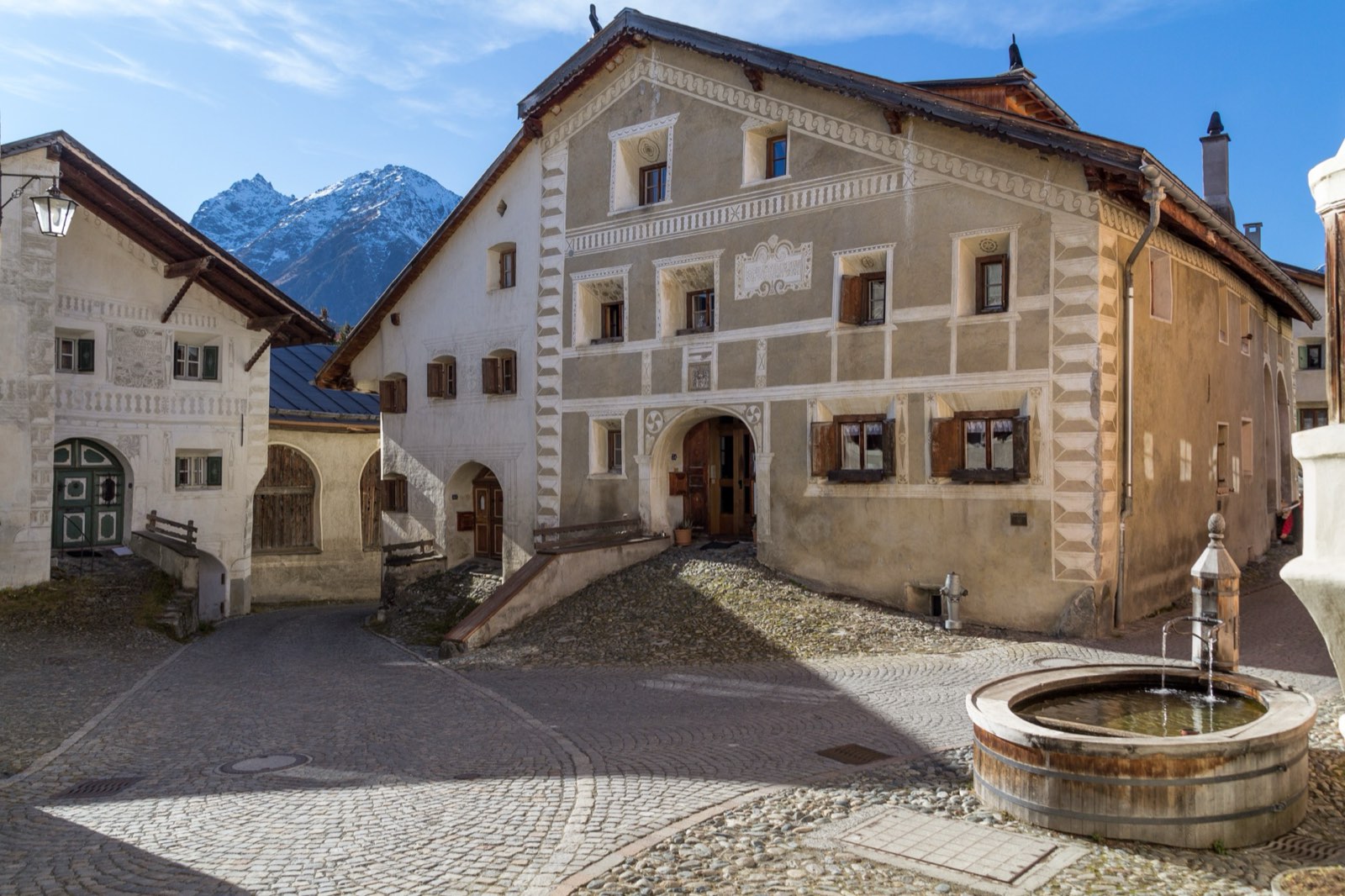 Engadin village house with sgraffito and wooden fountain